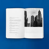 Open book with a black and white photograph of city skyline on a blue background