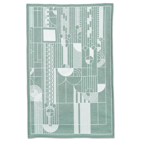 A green and white geometric patterned jacquard tea towel in Frank Lloyd Wright style.