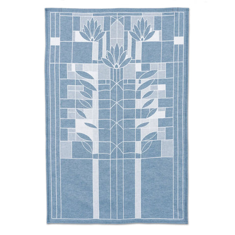 A blue and white geometric patterned tea towel featuring a floral design, inspired by Frank Lloyd Wright's 'Waterlilies' art glass window.
