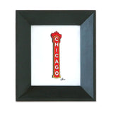 A framed print of the Chicago Theatre sign with a black wood frame and recycled glass.