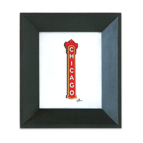 A framed print of the Chicago Theatre sign with a black wood frame and recycled glass.