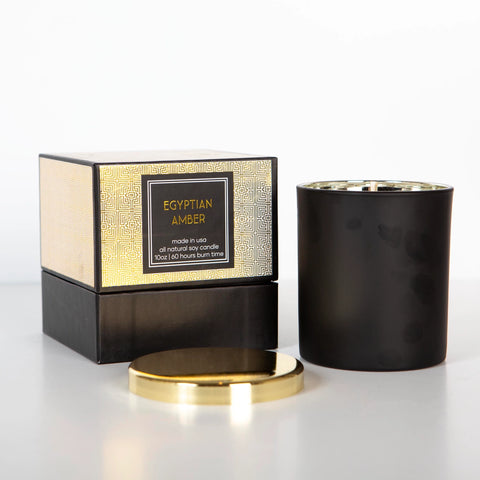 Egyptian Amber scented candle in a black jar with a gold lid, displayed with its packaging box.