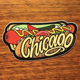 Sticker of a Chicago-style hot dog with text on a wooden surface