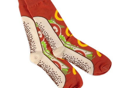 A pair of red socks with a Chicago-style hot dog design, featuring mustard, relish, onions, and tomatoes.