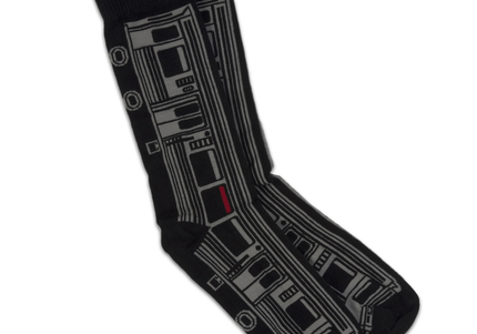 A pair of black socks featuring a design of a grey "L" train car.