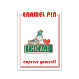 An enamel pin with a pigeon and a heart, sitting on a green Chicago street sign.