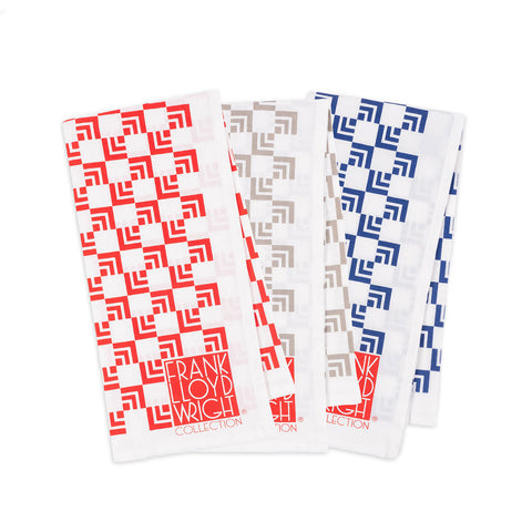 A set of three kitchen towels with a geometric nested squares design, featuring red, blue, and gray colors, and the text 'Frank Lloyd Wright Collection'.