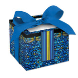 A rectangular note cube with a vibrant blue and yellow dragonfly design on a black background, adorned with a blue ribbon.