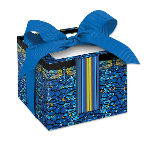 A rectangular note cube with a vibrant blue and yellow dragonfly design on a black background, adorned with a blue ribbon.