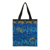 Canvas tote bag with a blue background and a pattern of dragonflies and plants.