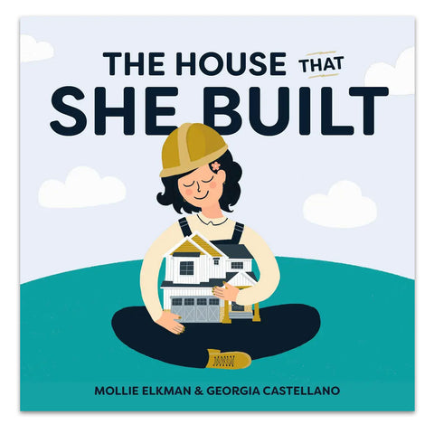 Cover of the children's book 'The House that She Built' featuring an illustration of a young girl in a hard hat construction hat, sitting and holding a house under construction.